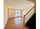 Bright entryway boasts wood floors, wainscoting, and stairs to the upper level at 1399 Dukes Creek Nw Dr, Kennesaw, GA 30152