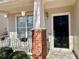Close up of front door with hanging plants and brick pillars at 1399 Dukes Creek Nw Dr, Kennesaw, GA 30152