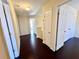 Upstairs hallway with hardwood floors and access to the bedrooms and attic at 1399 Dukes Creek Nw Dr, Kennesaw, GA 30152