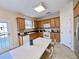 Bright kitchen with wood cabinets, white appliances, and a breakfast bar area at 1399 Dukes Creek Nw Dr, Kennesaw, GA 30152