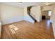 Spacious living room with wood floors and a staircase to the upper level at 1399 Dukes Creek Nw Dr, Kennesaw, GA 30152