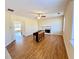 Cozy living room features a fireplace, ceiling fan, and wood floors at 1399 Dukes Creek Nw Dr, Kennesaw, GA 30152