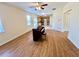 Spacious living room with a piano and access to the kitchen and dining area at 1399 Dukes Creek Nw Dr, Kennesaw, GA 30152