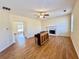 Cozy living room features a fireplace, ceiling fan, and wood floors at 1399 Dukes Creek Nw Dr, Kennesaw, GA 30152