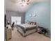 Bedroom features gray and blue walls, carpet, a ceiling fan, a window, and a desk at 1960 Overlook Springs Ln, Cumming, GA 30040