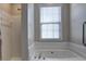Bright bathroom featuring a soaking tub and separate shower at 2357 Barrett Cottage Pl, Marietta, GA 30066