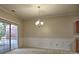 Dining room with chandelier, wainscoting detail, sliding glass door and neutral carpet flooring at 2357 Barrett Cottage Pl, Marietta, GA 30066