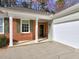 Exterior of home featuring brick and siding with green shutters and a two-car garage providing ample parking at 2357 Barrett Cottage Pl, Marietta, GA 30066