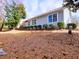 Exterior view of the home showing the yard and mature landscaping at 2357 Barrett Cottage Pl, Marietta, GA 30066