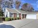 Charming home with a brick and siding exterior, complemented by a well-maintained lawn and an attached two-car garage at 2357 Barrett Cottage Pl, Marietta, GA 30066