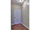 Foyer with wood-look floors, white door, neutral walls, and a ceiling light fixture providing a warm welcome at 2357 Barrett Cottage Pl, Marietta, GA 30066