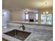 Open kitchen view into the living room with a granite counter and sink at 2357 Barrett Cottage Pl, Marietta, GA 30066