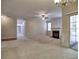 Spacious living room featuring a fireplace, neutral carpet, and a sliding glass door to the outdoors at 2357 Barrett Cottage Pl, Marietta, GA 30066