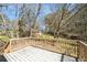 Wooden deck overlooking backyard trees on a sunny day at 304 Mercer Dr, Jonesboro, GA 30236