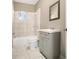 Bright bathroom features white tile, a shower-tub combo, and vanity at 304 Mercer Dr, Jonesboro, GA 30236