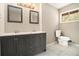 Bathroom features a dual vanity, a window, and modern fixtures at 304 Mercer Dr, Jonesboro, GA 30236