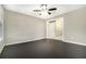 Bright room with neutral walls, dark hardwood flooring, ceiling fan and a doorway entrance at 304 Mercer Dr, Jonesboro, GA 30236