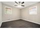Bright bedroom featuring two windows and a ceiling fan at 304 Mercer Dr, Jonesboro, GA 30236