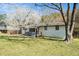 Classic home boasts a brick facade, covered porch, and a serene yard with mature trees and greenery at 304 Mercer Dr, Jonesboro, GA 30236