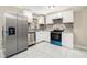 Modern kitchen with stainless steel appliances, white cabinets, granite countertops, and tile flooring at 304 Mercer Dr, Jonesboro, GA 30236