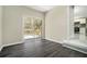 Stylish living room with wood floors, sliding glass doors with a deck view, leading into the kitchen at 304 Mercer Dr, Jonesboro, GA 30236