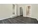 Cozy living room with hard wood floor, showing entries to other rooms in the house at 304 Mercer Dr, Jonesboro, GA 30236