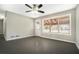 Bright living room with neutral walls, dark hardwood flooring, ceiling fan and a glass door at 304 Mercer Dr, Jonesboro, GA 30236