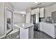Well-lit kitchen featuring stainless steel appliances, an island with seating, and modern backsplash at 898 Oak Sw St # 1306, Atlanta, GA 30310