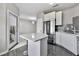 Modern kitchen features stainless steel appliances, white cabinets and a light countertop island with seating at 898 Oak Sw St # 1306, Atlanta, GA 30310