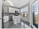 Modern kitchen features stainless steel appliances, island with seating, and sleek white cabinets at 898 Oak Sw St # 1306, Atlanta, GA 30310