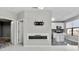 Well-lit living room with fireplace and tv, leading into a modern white kitchen at 898 Oak Sw St # 1306, Atlanta, GA 30310