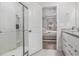 Elegant bathroom showcasing a glass shower and granite-topped vanity, adjacent to a serene bedroom at 1593 Maston Rd, Auburn, GA 30011