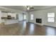 Open-concept living room connected to the kitchen, featuring a cozy fireplace at 1952 Chapel Estates Ln, Dacula, GA 30019