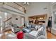 Open-concept living room features hardwood floors, staircase and view into the eat-in kitchen at 3723 Mossbrook Ter, Suwanee, GA 30024