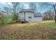 Expansive backyard featuring a deck perfect for outdoor entertaining and mature trees offering shade at 6112 Shadow Rock Ln, Lithonia, GA 30058