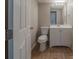 Bathroom with a white vanity, updated fixtures, and wood-look flooring at 6112 Shadow Rock Ln, Lithonia, GA 30058
