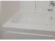 Close up of a white bathtub with chrome fixtures and surround at 6112 Shadow Rock Ln, Lithonia, GA 30058