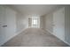Spacious bedroom with three doors, neutral carpet, and natural light at 6112 Shadow Rock Ln, Lithonia, GA 30058