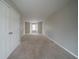 Spacious bedroom with two doors, neutral carpet, and natural light at 6112 Shadow Rock Ln, Lithonia, GA 30058