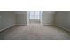 A large bedroom with carpet, grey paint and natural light from the window at 6112 Shadow Rock Ln, Lithonia, GA 30058