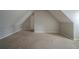 Neutral attic bedroom with carpet and sloped walls at 6112 Shadow Rock Ln, Lithonia, GA 30058