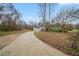 View of the home's exterior, front lawn, long driveway and some winter landscaping at 6112 Shadow Rock Ln, Lithonia, GA 30058