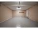 Clean, well-lit garage with concrete floor, storage shelf, and service door at 6112 Shadow Rock Ln, Lithonia, GA 30058
