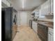 This kitchen is complete with white cabinets, black appliances and tile flooring at 6112 Shadow Rock Ln, Lithonia, GA 30058