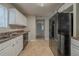 An open kitchen with stainless steel sink, dishwasher, large fridge and tile flooring at 6112 Shadow Rock Ln, Lithonia, GA 30058