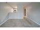 Spacious living room with neutral paint, carpet and view of kitchen at 6112 Shadow Rock Ln, Lithonia, GA 30058