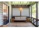 Inviting screened porch with a woven pendant light and a cozy bench at 105 Terrace Ne Dr, Atlanta, GA 30305