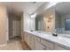 Bathroom with double vanity featuring white cabinets and marble countertop at 1160 Faulkner Way, Jonesboro, GA 30238