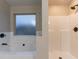 An elegant bathroom boasts a soaking tub, a walk-in shower, and brushed bronze fixtures at 1160 Faulkner Way, Jonesboro, GA 30238