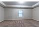 Neutral bedroom with plush carpet, a window, and a tray ceiling design at 1160 Faulkner Way, Jonesboro, GA 30238